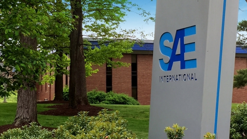 SAE International logo displayed on a sign outside a corporate building